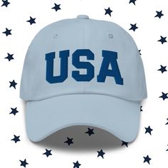 "Everyone needs this classic USA hat in their wardrobe this summer and for all your 4th of July activities. Our baseball cap features high quality 3D puff embroidery in royal blue thread. It has an adjustable strap for the perfect fit too!  Dad hats aren't just for dads. This one's got a low profile with an adjustable strap and curved visor. * 100% chino cotton twill * Green Camo color is 35% chino cotton twill, 65% polyester * Unstructured, 6-panel, low-profile * 6 embroidered eyelets * 3 ⅛\" ( 4th Of July Activities, July Activities, Cap America, Patriotic Hats, Trendy Hat, Blue Embroidery, Camo Colors, Womens Baseball Cap, Summer Hat