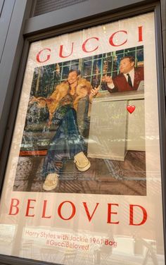 an advertisement for gucci's beloved brand is displayed in a store window