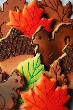 decorated cookies with leaves and acorns on a table