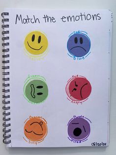 a notebook with different colored smiley faces and words on the cover that read match the emotions