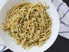 a white bowl filled with pasta covered in sauce