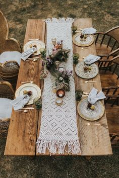 the table is set with plates and place settings