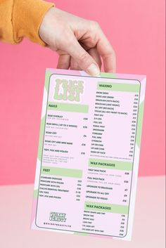 a person is holding up a menu for a restaurant or bar on a pink and green background