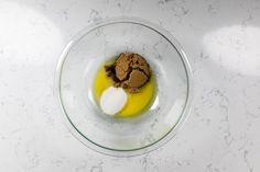 a glass bowl filled with food on top of a white counter