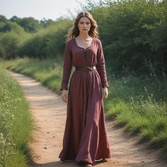 This rustic brown Viking-inspired dress captures the essence of medieval and Renaissance fashion. This gown is perfect for reenactments, festivals, and cosplay events. The lace-up front and leather belt add a historical touch, making this outfit ideal for anyone seeking an authentic Viking look. Comfortable for long days at festivals, this versatile gown offers both practicality and style, perfect for any history lover or event attendee. Whether you're dressing up for a Viking festival or attending a Renaissance fair, this simple yet elegant gown will transport you back in time. I hope you will love my design as much as I enjoyed creating it for you! ----Important Information---- Please, be aware that all pictures are designer's illustrations. The actual product may slightly differ in look Viking Inspired Outfit, Narnia Costumes, Viking Festival, Minimalist Cottagecore, Dress Medieval, Viking Dress, Festival Costume, Festival Costumes, Medieval Dress