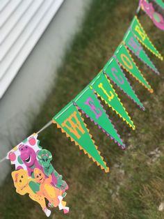 there is a banner that says happy new year hanging from a line on the grass