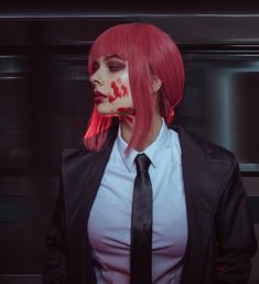 a woman with red hair and makeup wearing a tie