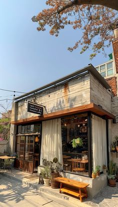 the outside of a restaurant with tables and chairs