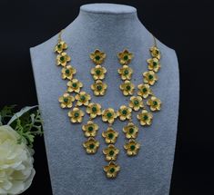 These gorgeous Fusion 3D flower necklace set can be styled gracefully with any outfit.  Necklace has adjustable chain. Earring length: 2" Earring Push-Back closure.  Light Weight. Finish: Gold plated on high-quality brass as base metal. Availability: In-Stock. *Color may vary slightly due to light condition & photography. Jewelry Care:  Keep away from moisture. Allow perfumes and lotion to dry before wearing. Store in jewelry pouch. Clean only with soft lint free cloth. Emerald Green Necklace, Photography Jewelry, Chain Earring, Pakistani Jewelry, American Diamond, Green Necklace, Chain Earrings, Silver Bangles, Jewelry Pouch