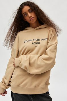 Oversized fit pullover hoodie sweatshirt by Tee Library with slogan text printed at the front. Cotton poly blend sweatshirt with a hood and ribbed knit trims. Features Tee Library Stupid Story Lover hoodie sweatshirt Oversized fit pullover sweatshirt Hooded Front graphic Oversized Ribbing trims Content + Care 60% Cotton, 40% polyester Machine wash Imported Size + Fit Model in Tan is 5’9" and wearing size Medium Measurements taken from size Medium Chest: 52" Length: 30" | Tee Library Stupid Story Lover Hoodie Sweatshirt in Tan at Urban Outfitters Women's Graphic Tees, Vintage Graphic Tees, Sweatshirt Oversized, Urban Outfitters Women, Graphic Tees Vintage, Vintage Graphic, Clothes Crafts, Tees For Women, Edgy Look