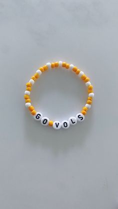 Show your school pride and complete your game day outfit with a custom orange and white beaded bracelet for the University of Tennessee! Personalized Orange Beaded Bracelets For Friendship, Personalized White Stretch Bracelet Casual Style, Casual Personalized White Stretch Bracelet, Casual Customized White Wristband, Casual White Wristband With Round Beads, Casual White Personalized Stretch Bracelet, Casual White Round Bead Wristband, Casual White Beaded Name Bracelet, Casual White Round Beads Wristband