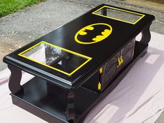 a coffee table made to look like a batman symbol on the top and bottom part of it