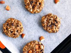 three cookies with nuts and chocolate chips on top