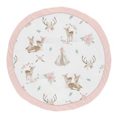 a white and pink round rug with deer, flowers and teepees on it