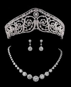 Royal CZ Tiara Crown with Jewelry Set This fabulous cz set with tiara and coordinating jewelry will provide show-stopping elegance for your big day! This tiara is a replica of a tiara worn by Imelda Marcos. This regal tiara features a stunning scroll design plated in genuine platinum silver. It is adorned with meticulous micro-pave detailing with AAAAA quality cubic zirconia crystals. It's ornate detailing and 2" tall presence will ensure head-turning drama on your wedding day. The coordinating Rose Gold Headband, Gold Bridesmaid Jewelry, Pearl Headband Wedding, Pearl Bridesmaid Jewelry, Rose Gold Wedding Jewelry, Pearl Bracelet Wedding, Flower Girl Jewelry, Headpiece Jewelry, Bridesmaid Pearls