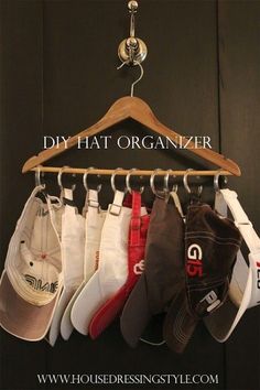 several hats are hanging on a wooden hanger