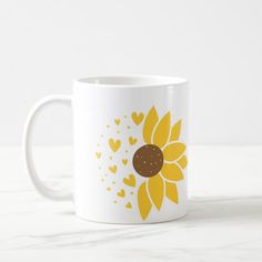 a coffee mug with a sunflower and hearts on it