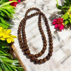 Experience the natural beauty of Hawaiian Koa Wood with our handcrafted beaded necklace or bracelet. Each 8mm bead showcases the unique and popular wood, adding a touch of island-inspired style to your outfit. At 32 inches, this versatile piece can be worn as either a necklace or a double/triple wrapped bracelet. Material: Koa Wood Bead Size: 8mm Size: 32 inches Bracelet or Necklace More about Woods of Hawaii: CLICK HERE Tropical Jewelry, Tropical Home Decor, Koa Wood, Wood Necklace, Wood Beads, Natural Beauty, Hand Carved, Hawaii, Beaded Necklace