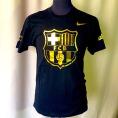 Barcelona Men's T-Shirt *Color: Black & Gold *Condition: New With Tags, No Damage, No Stains. *Size: M *Material: Cotton **Garment Care: Hand Wash & Natural Air Dry Your Garment. **Real Pictures, What You See Is What You Get! (Please Have In Mind That The Item Color May Look Different Due To Lightning During Photo Shooting Or Your Monitor/Screen Display Settings). Open To Offers, Thank You! :) Nike Black Fan Apparel T-shirt, Black Logo Print Shirt For Fans, Black Shirt With Logo Print For Fans, Black Fan Apparel Shirt With Logo Print, Messi T Shirt, World Series Shirts, Compression T Shirt, Combat Shirt, Maroon Shirts