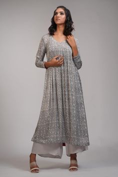 Grey anarkali with floral hand block print and gathered detailing. Paired with palazzo.
Components: 2
Pattern: Hand Block Printed
Type Of Work: Floral
Neckline: V neck
Sleeve Type: Long sleeves
Fabric: Modal Satin
Color: Grey
Other Details: 
Approx weight: 5-7 kgs
Model height: 5ft 9inches, wearing size M
Occasion: Puja - Aza Fashions Unstitched Self Design Anarkali Set For Reception, Anarkali Kurta With Mirror Work For Reception, Anarkali Maxi Kurta For Reception, Anarkali Style Maxi Length Palazzo Set For Reception, Anarkali Palazzo Set For Reception, Silver Designer Saree Dress, Designer Silver Saree Dress, Designer Anarkali Silver Kurta, Designer Semi-stitched Silver Anarkali Set