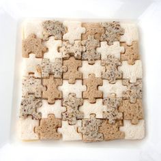 a white plate topped with lots of cut up pieces of bread next to each other