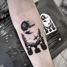 a black and white photo of a person with a tattoo on his arm that has an image of a space shuttle flying through the sky