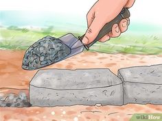 a person is using a knife to cut rocks with a stone block in the foreground