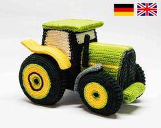 a toy tractor made out of yarn on a white background