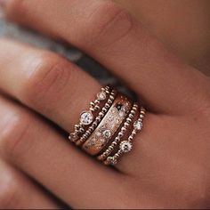 a woman's hand with three different rings on top of her finger and the words lslunaskye written above it