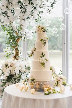 a white wedding cake sitting on top of a table