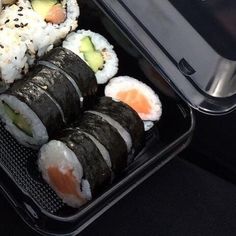 there are sushi rolls in the container on the table