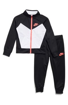 This sporty set pairs a woven tricot jacket with coordinating joggers that are complete with classic Nike branding. Includes jacket and joggers 100% polyester Machine wash, tumble dry Imported Spring Sportswear Tracksuit For Running, Fall Sports Sets Sportswear, Spring Sportswear Tracksuit, Fall Sportswear Sets For Sports, Sporty Sets For Fall Sports, Sporty Fall Sports Sets, Nike Sporty Winter Sets, Sporty Nike Winter Sets, Sporty Fleece Sets For Fall