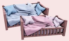 two wooden beds with pillows and blankets on top of each bed, one is pink and the other is blue