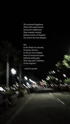 an empty street at night with a poem written in the dark on it's side