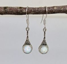 "Opal silver dangle earrings, dainty drop earrings with white opals. Unique bohemian jewelry for women and girls. Available with a variety of gemstones: blue opals, garnets, aquamarine, and pearls, and with gold plating. Opal- Is the birthstone for the month of October, it represents hope, faith, and good luck. 🌸 Product details: Handmade earrings 🌸 Measurements: Weight - 2 g Length - 1.2\" (3 cm) Width - 0.3\" (0.75 cm) Stone diameter - 0.23\" (6 mm) 🌸Materials: Sterling silver White opals ? Handmade Opal Earrings In Silver, Silver Opal Dangle Jewelry, Silver Dangle Opal Earrings, Silver Opal Dangle Earrings, White Opal Drop Earrings, Elegant Adjustable Opal Earrings, Silver Cabochon Dangle Earrings, Elegant Silver Opal Earrings, Silver Opal Drop Jewelry