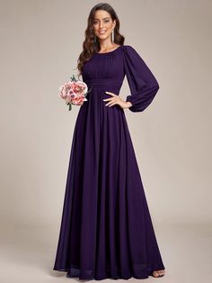 a woman in a long purple dress posing for the camera