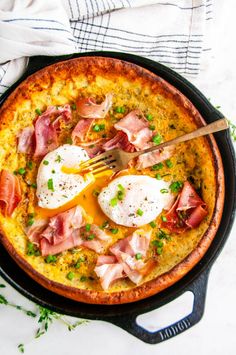 an omelet with ham and eggs in a skillet