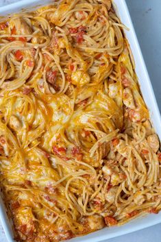 a casserole dish with chicken, cheese and tomato sauce