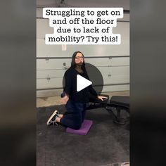 a woman sitting on top of a purple yoga mat in front of a garage door