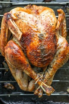 a roasted turkey on a grill with mushrooms