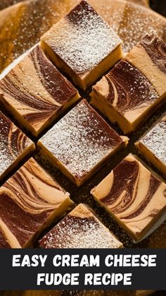 easy cream cheese fudge recipe on a plate with powdered sugar and chocolate squares