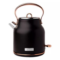 a black kettle with a copper handle on the top and bottom, sitting in front of a white background