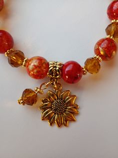 Sunflower charm stretch bracelet 10mm ceramic /8mm glass beads gold tone accents Gift Stretch Bracelet With Round Beads And Extender, Gold Beaded Stretch Bracelet With Czech Glass, Spiritual Gold Bracelet With Czech Glass, Spiritual Gold Bracelets With Czech Glass, Gold Czech Glass Beaded Bracelets, Sunflower Charm, Sun City, Beads Bracelet Design, Love Charms