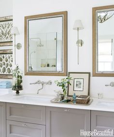 a bathroom with two sinks and mirrors on the wall