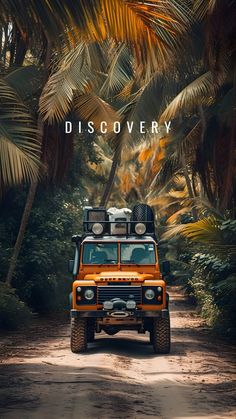 an orange jeep driving down a dirt road surrounded by trees and palm trees with the words discovery written on it