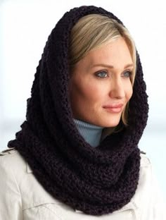 a woman wearing a knitted cowl scarf