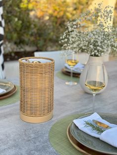 the table is set with plates and wine glasses