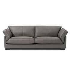 a gray couch sitting on top of a white floor