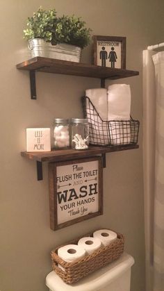 a bathroom with two shelves above the toilet