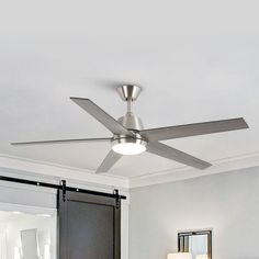 a ceiling fan in a bedroom with white walls